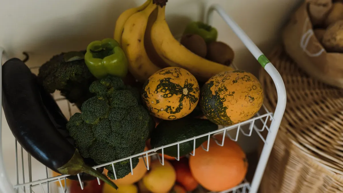 A vibrant assortment of fruits and vegetables on a kitchen rack, showcasing health and nutrition.