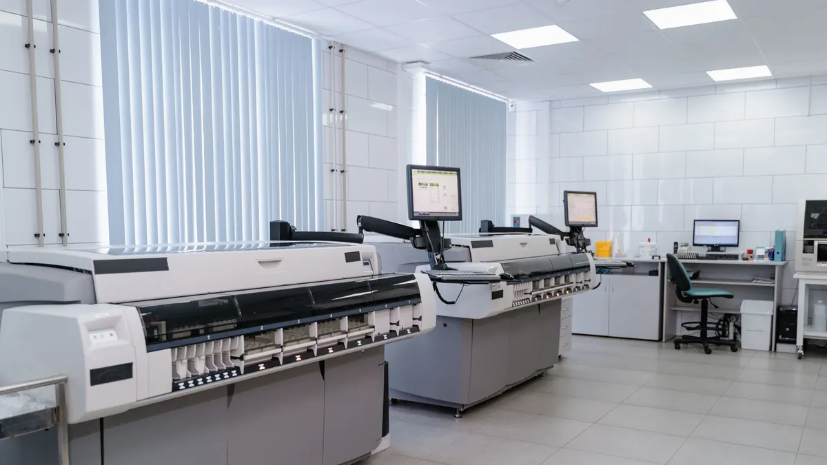 Spacious modern laboratory featuring advanced printing equipment and workstations.
