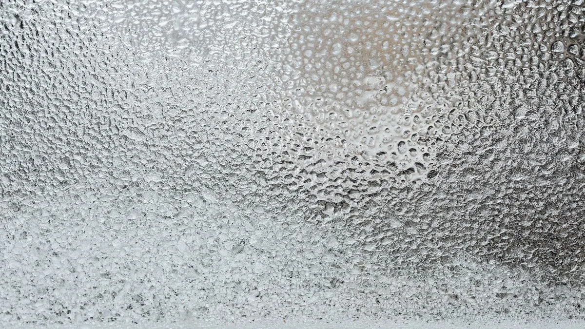 A detailed view of a frosted glass surface, capturing the icy texture and winter ambiance.