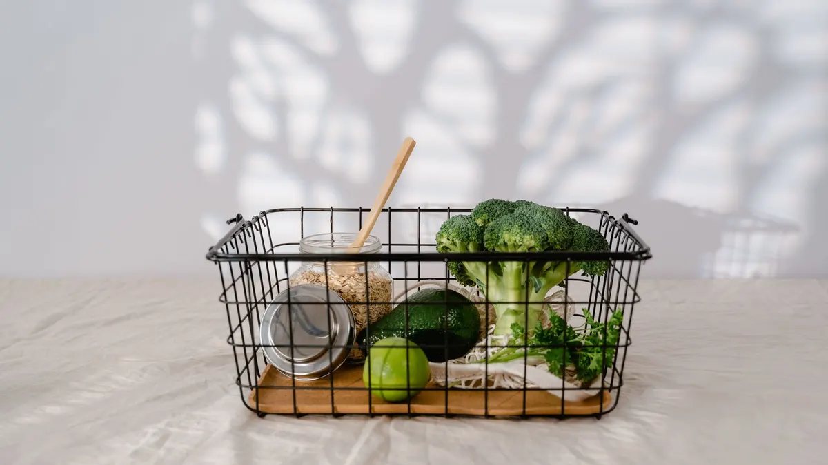 Metal basket with organic vegetables and grains emphasizing zero waste lifestyle.