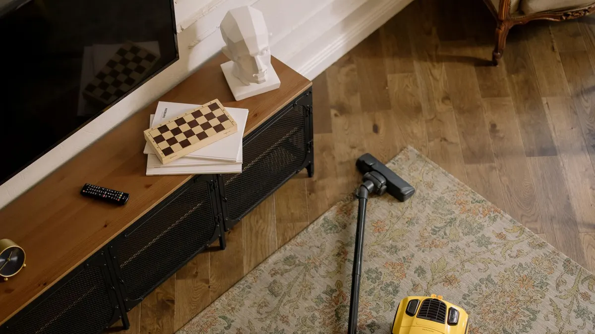 Warm living room scene featuring a yellow vacuum on a floral carpet with a vintage vibe.