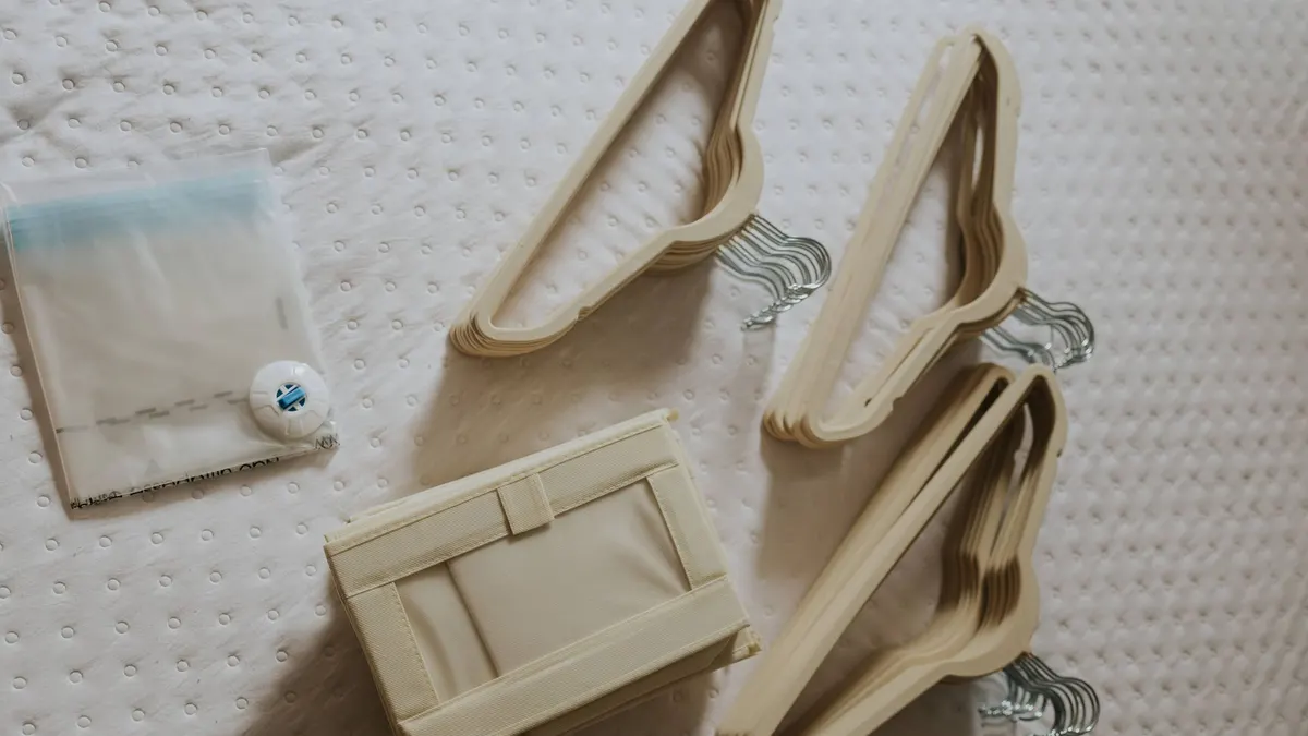 A neatly arranged flat lay of beige wooden hangers and a fabric storage box on a quilted surface.