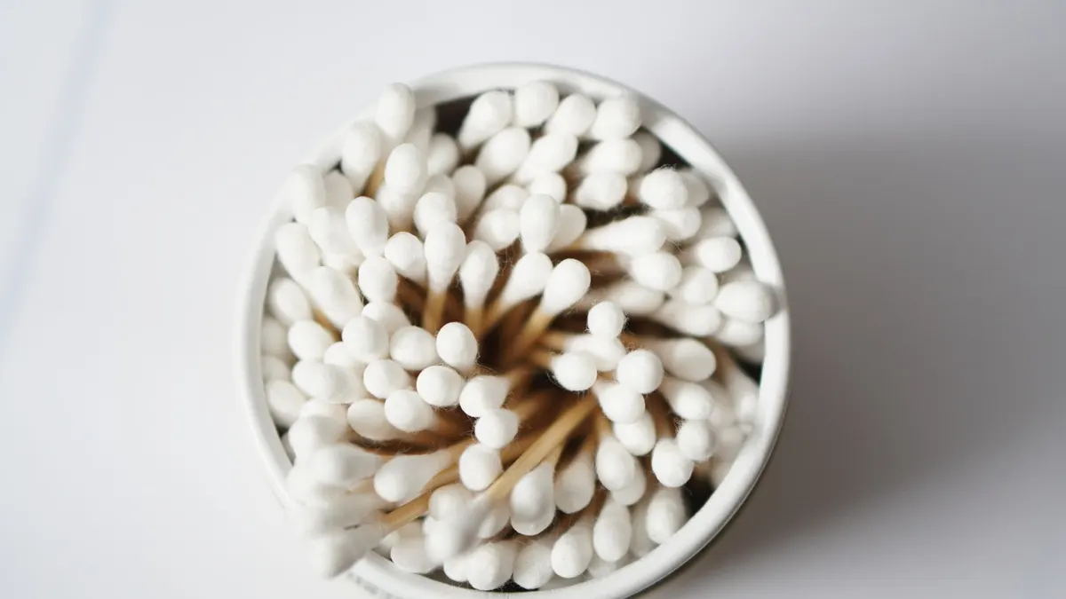 Top view of cotton buds stacked in a container, emphasizing hygiene and healthcare.